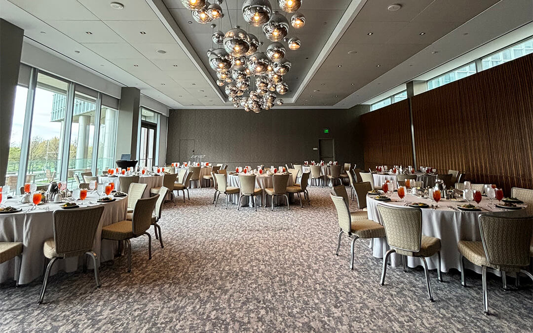 Several round tables in a ballroom for the OKC CDA luncheon. 